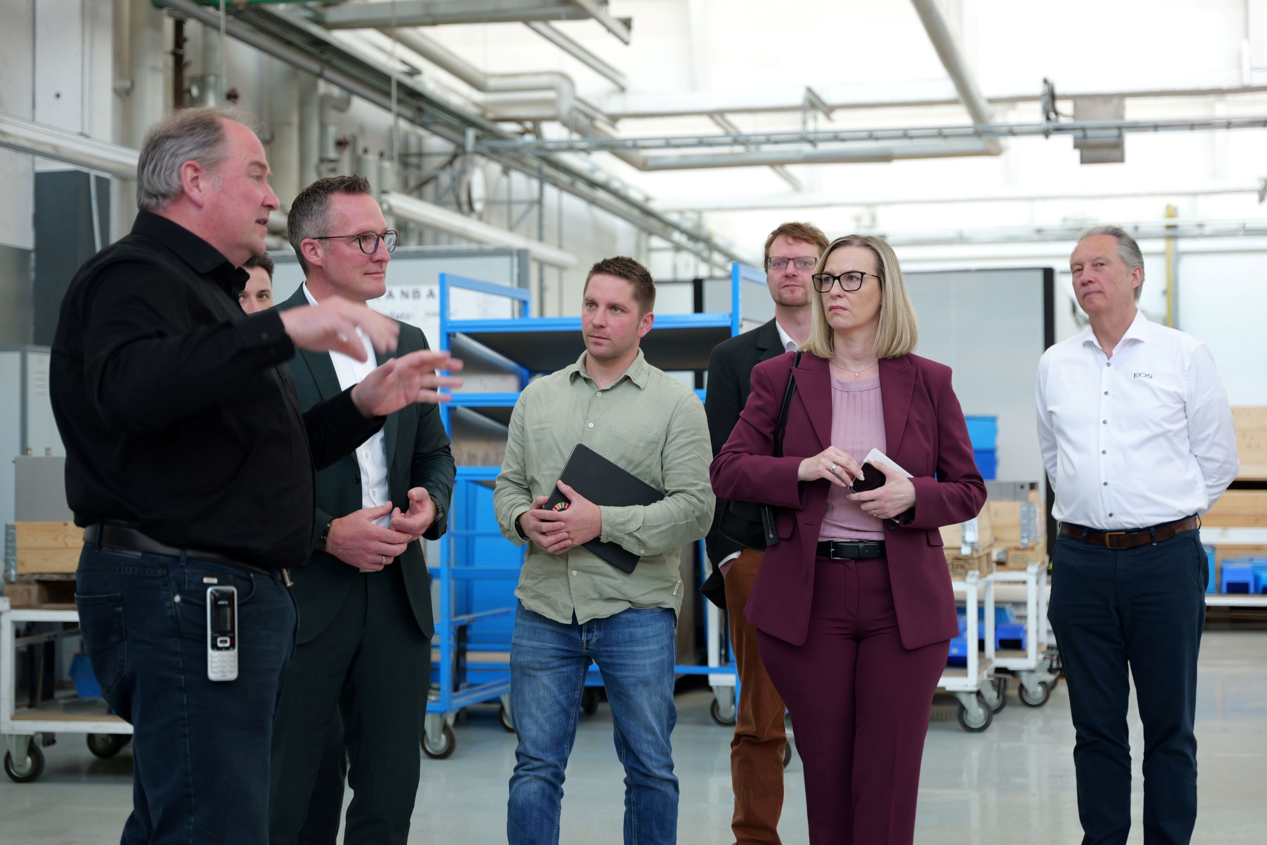 Die Wirtschaftsdelegation des Lahn-Dill-Kreises informierte sich in der Produktion über die Unternehmensentwicklung, aktuelle Investitionen sowie Zukunftsperspektiven der EOS Saunatechnik GmbH. V. l. n. r.: Andreas Ehresmann (Technischer Leiter EOS Saunatechnik GmbH), Landrat Carsten Braun, Jacob Manderbach (Kreis-Wirtschaftsförderung), Dr. Sven Saage (IHK Lahn-Dill), Petra Kern (Agentur für Arbeit), Philipp Krauth (Geschäftsführer EOS Saunatechnik GmbH). Foto: Blurry-Face-Visuals